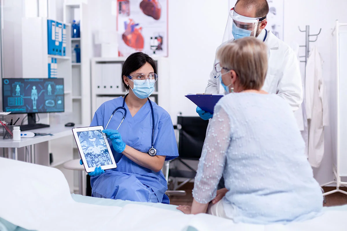 Equipe médica orientando paciente em ambiente clínico